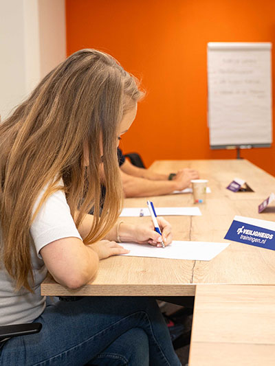Cursist schrijft mee tijdens cursus omgaan met ongewenst gedrag